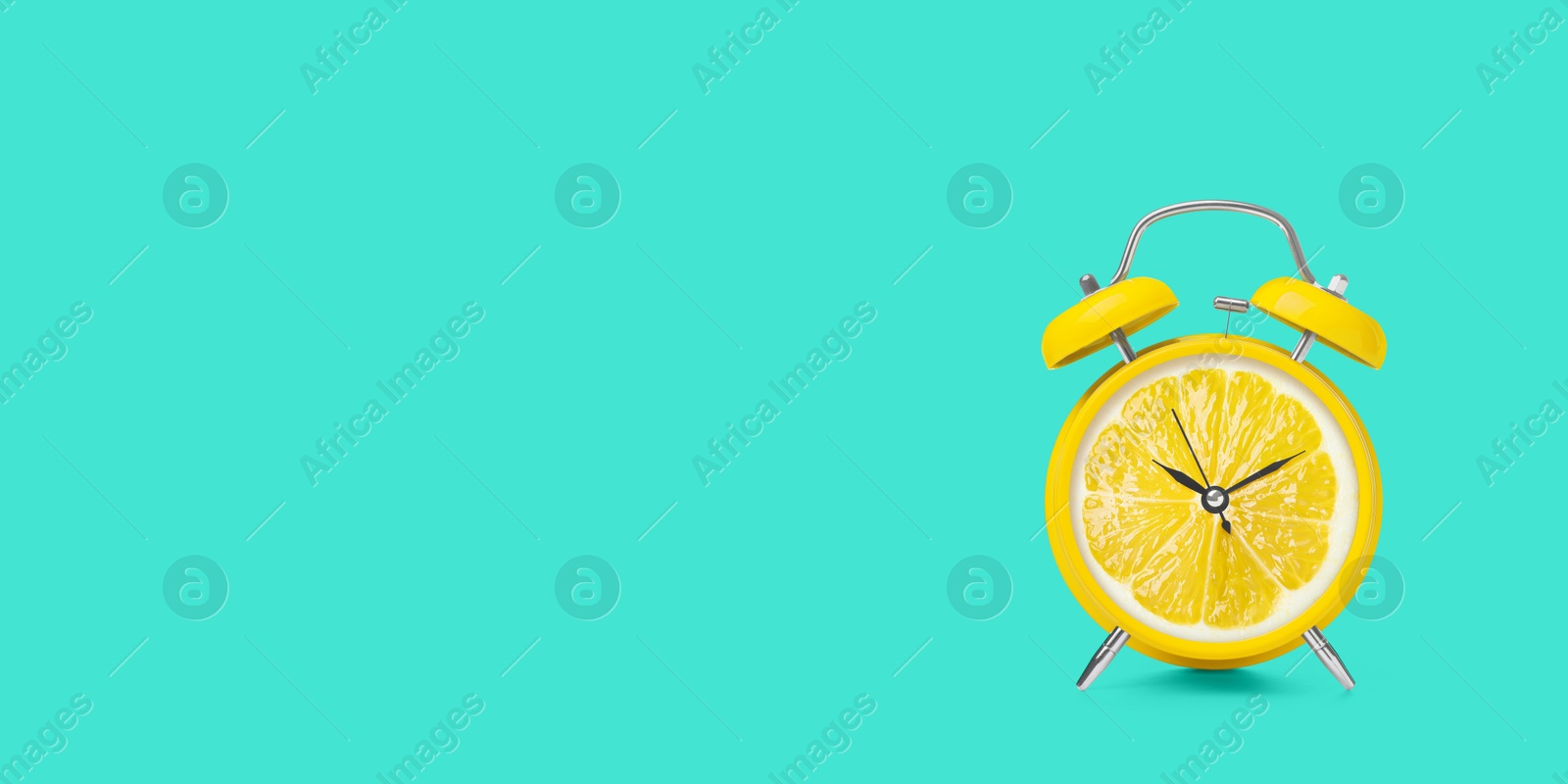 Image of Juicy lemon on alarm clock dial against turquoise background. Creative poster with space for text, banner design