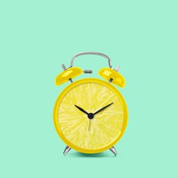 Juicy lemon on alarm clock dial against light turquoise background. Creative poster