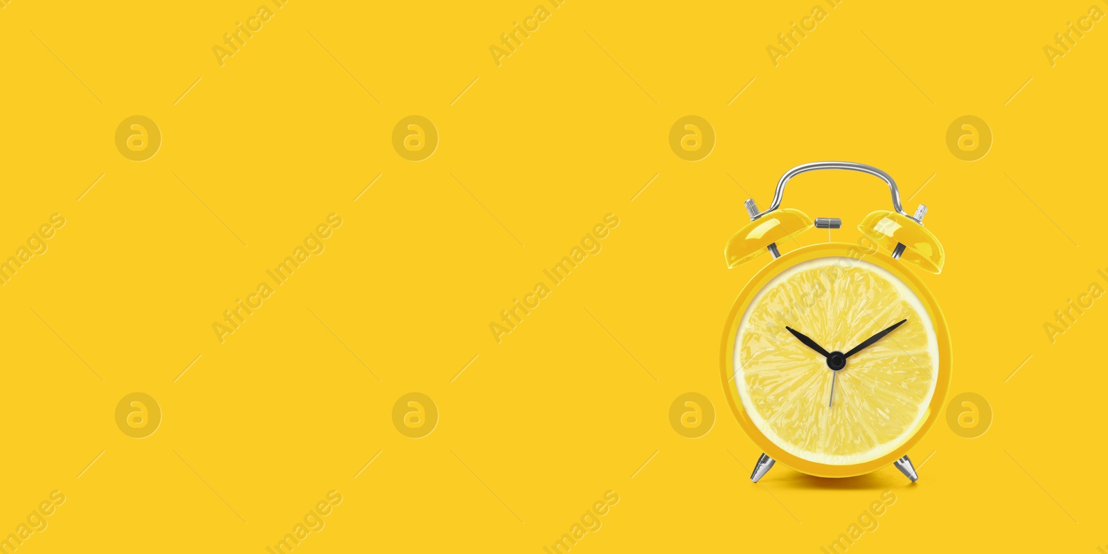 Image of Juicy lemon on alarm clock dial against yellow background. Creative poster with space for text, banner design