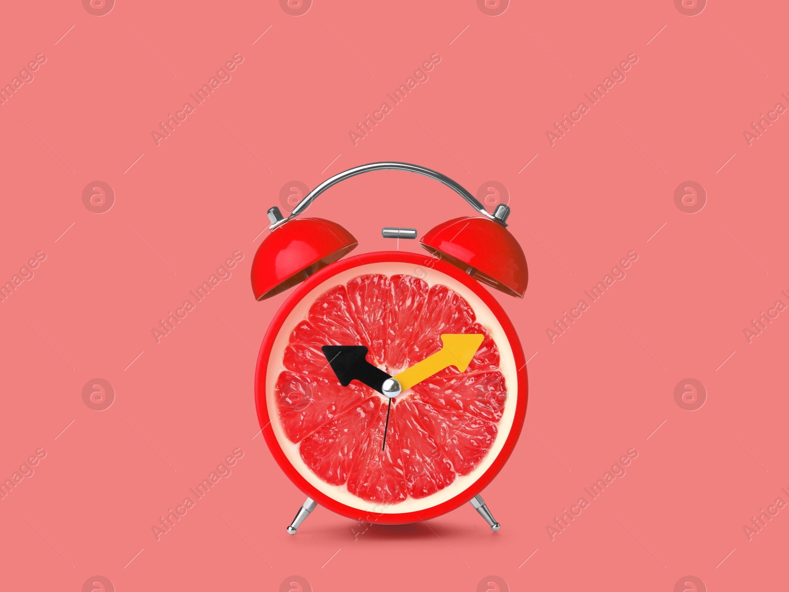 Image of Juicy grapefruit on alarm clock dial against pink background. Creative poster