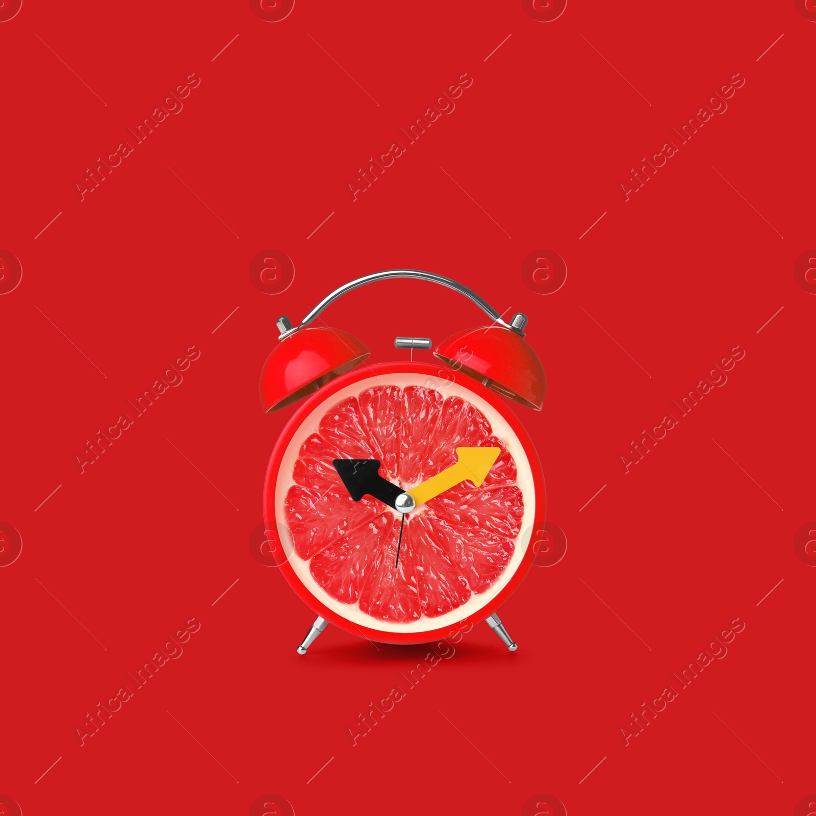 Image of Juicy grapefruit on alarm clock dial against red background. Creative poster