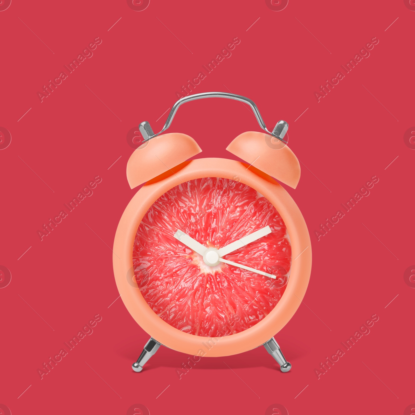 Image of Juicy grapefruit on alarm clock dial against crimson background. Creative poster