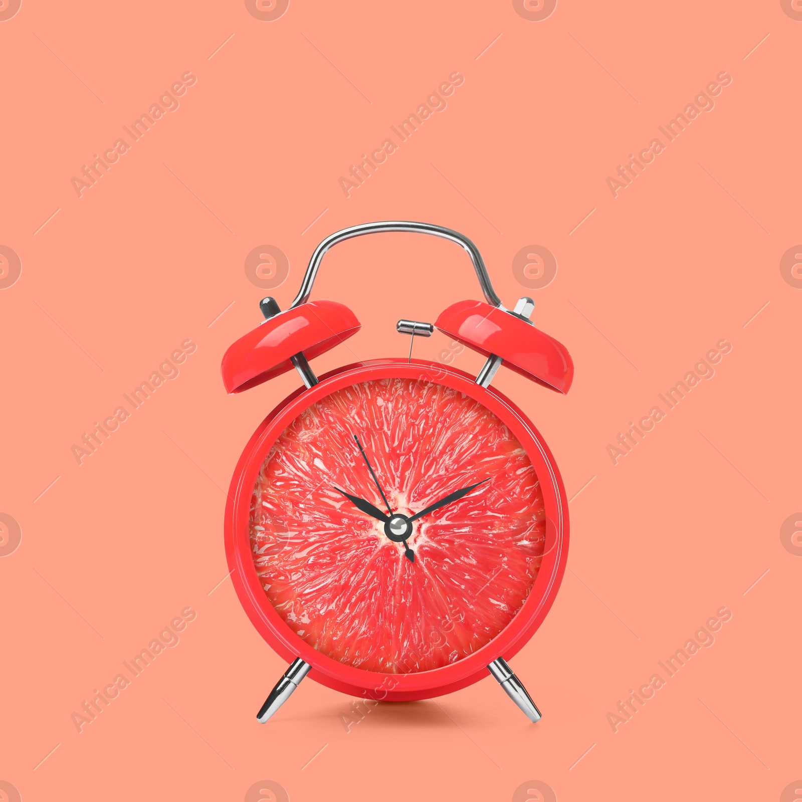 Image of Juicy grapefruit on alarm clock dial against pink background. Creative poster