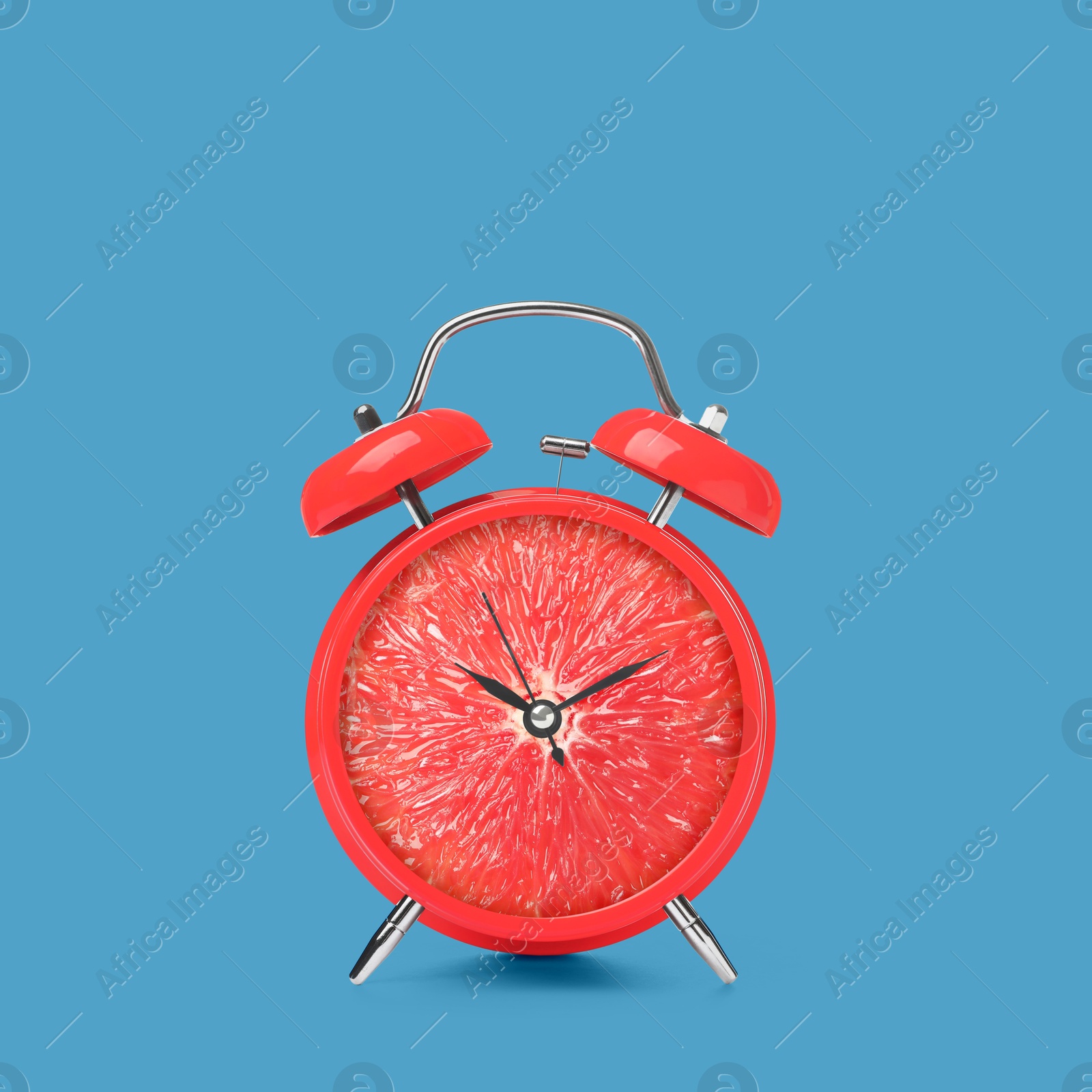 Image of Juicy grapefruit on alarm clock dial against blue background. Creative poster