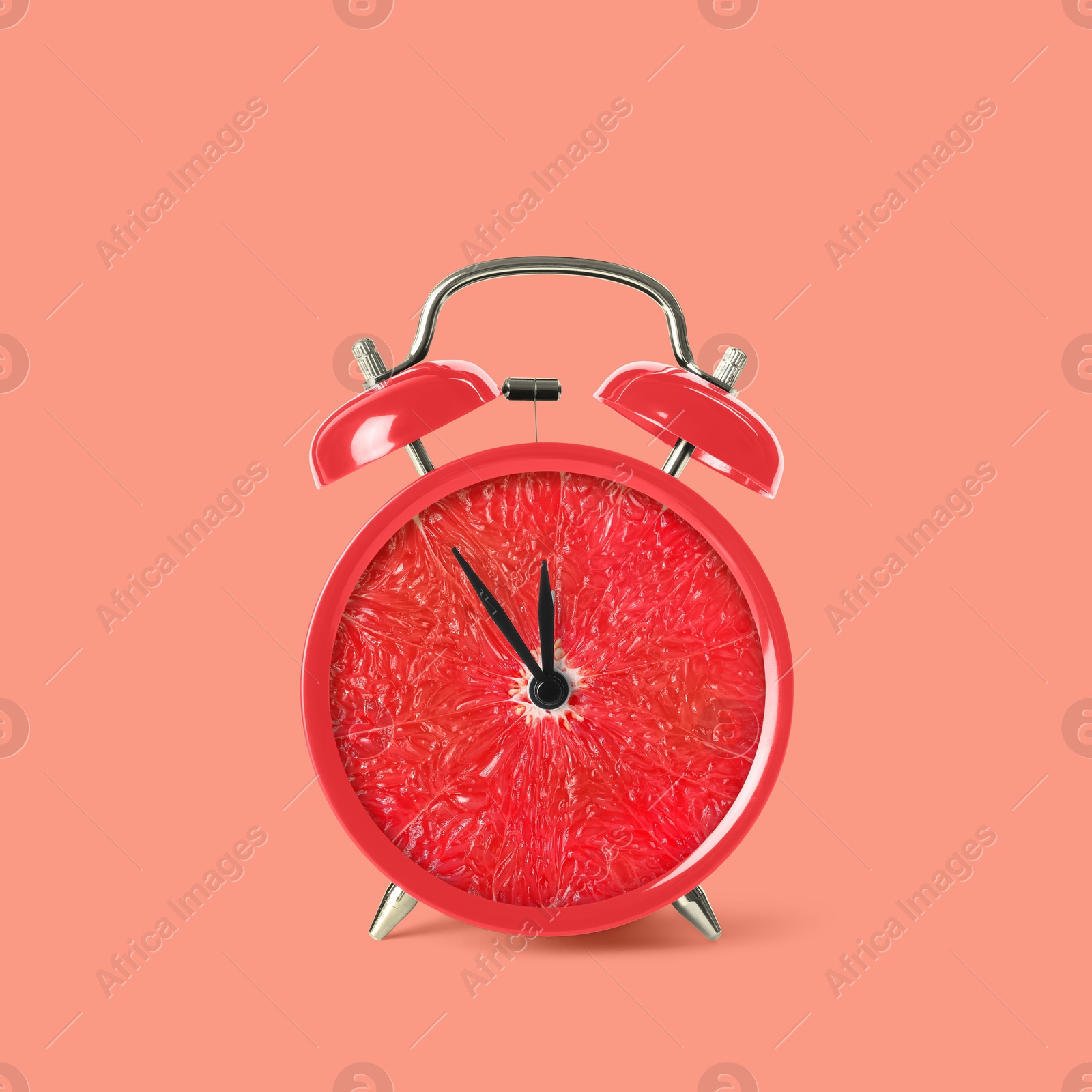 Image of Juicy grapefruit on alarm clock dial against pink background. Creative poster