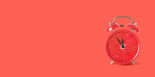 Image of Juicy grapefruit on alarm clock dial against red background. Creative poster with space for text, banner design