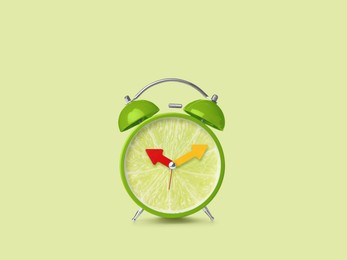 Image of Juicy lime on alarm clock dial against light green background. Creative poster