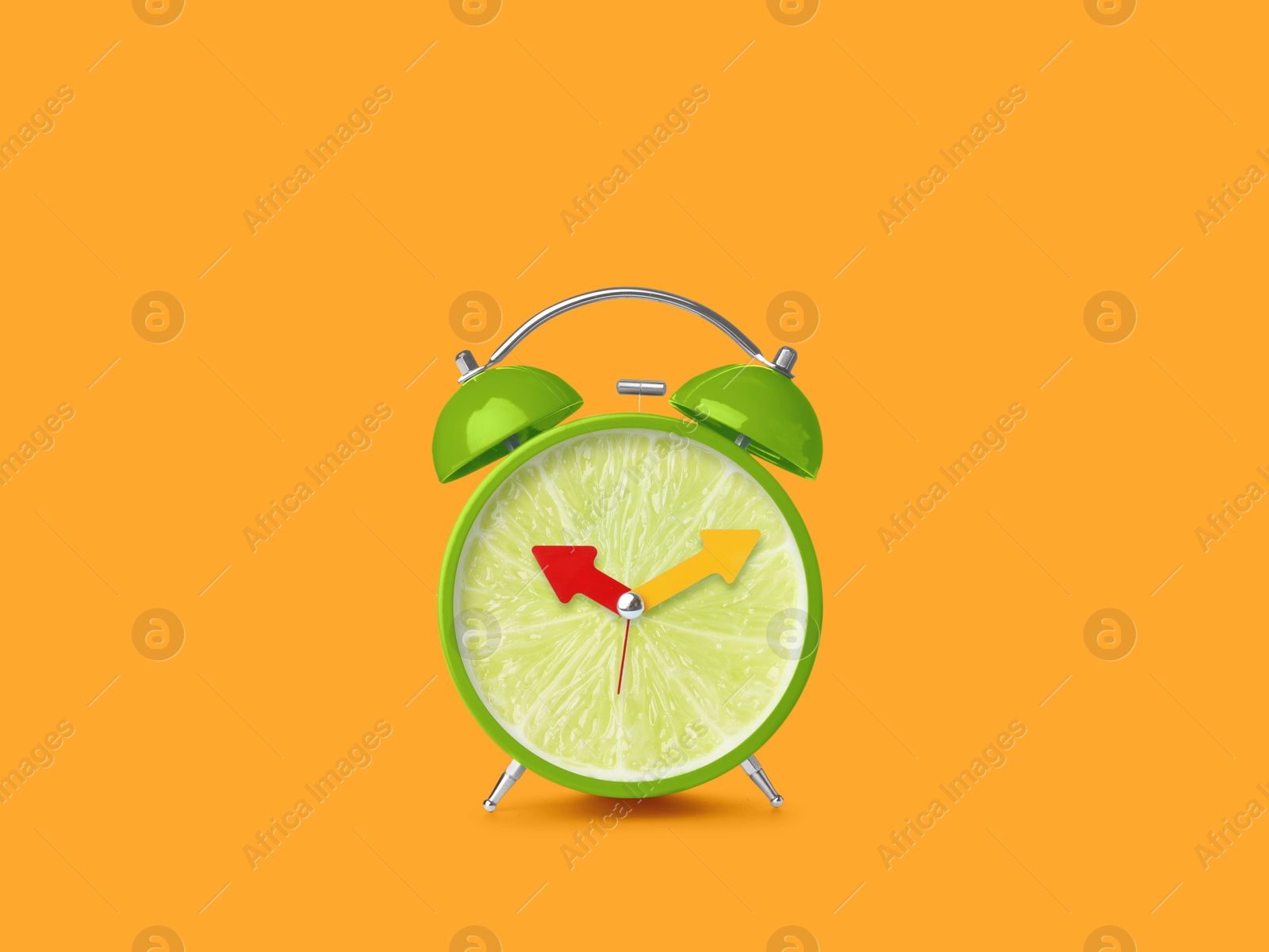 Image of Juicy lime on alarm clock dial against orange background. Creative poster