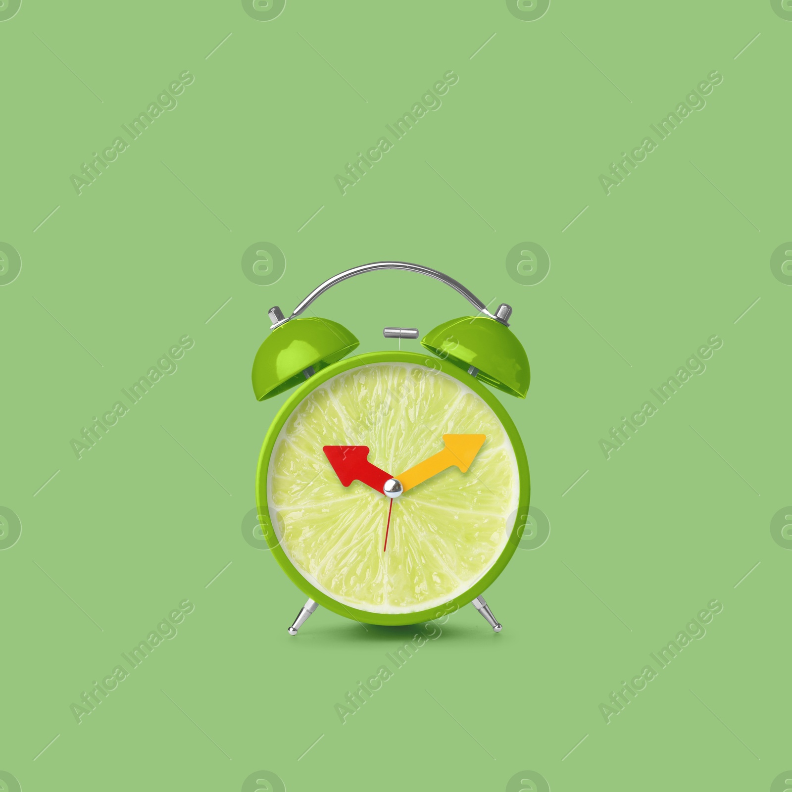 Image of Juicy lime on alarm clock dial against light green background. Creative poster