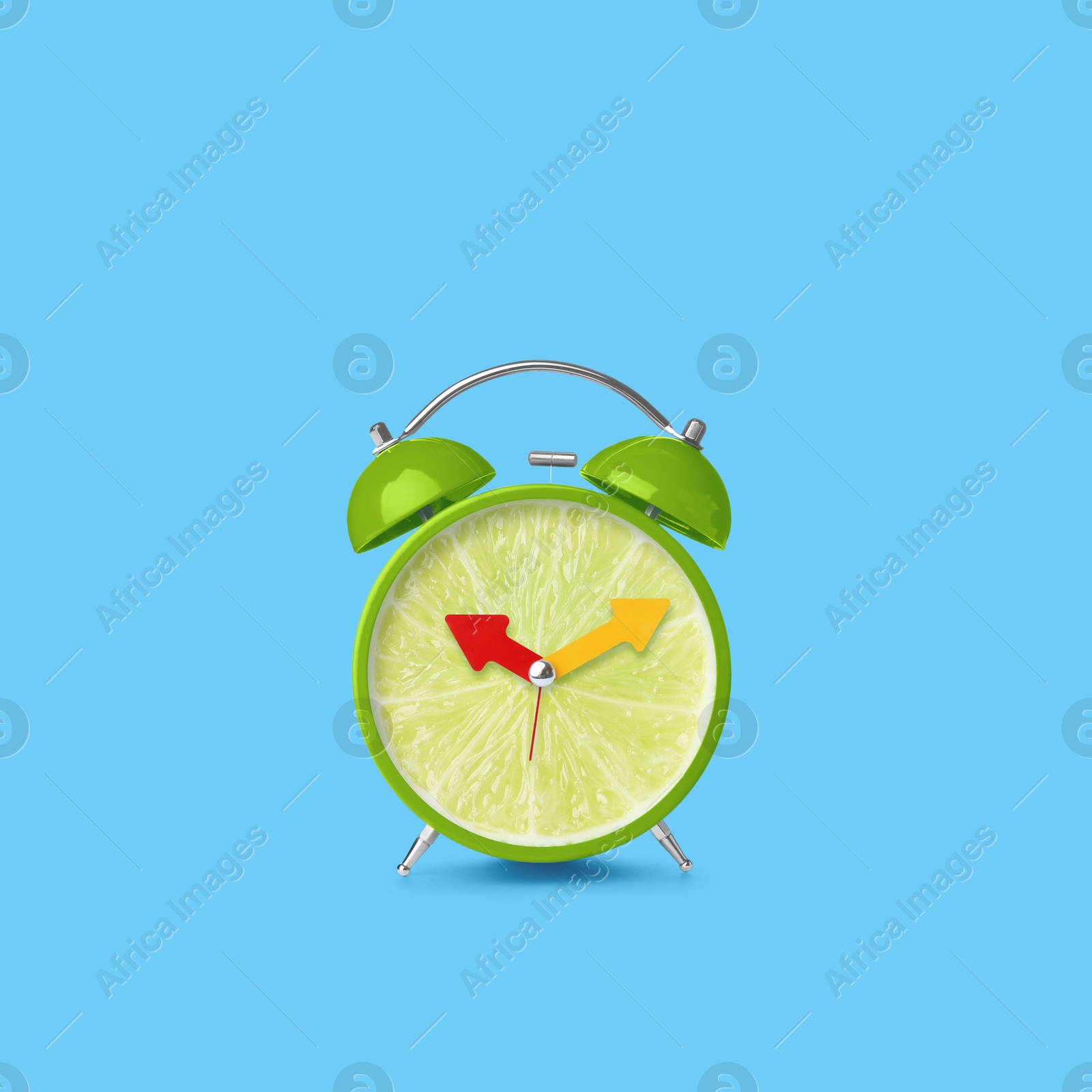 Image of Juicy lime on alarm clock dial against light blue background. Creative poster