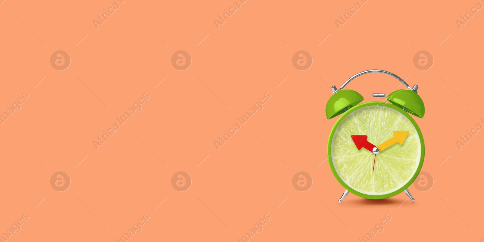 Image of Juicy lime on alarm clock dial against coral background. Creative poster with space for text, banner design