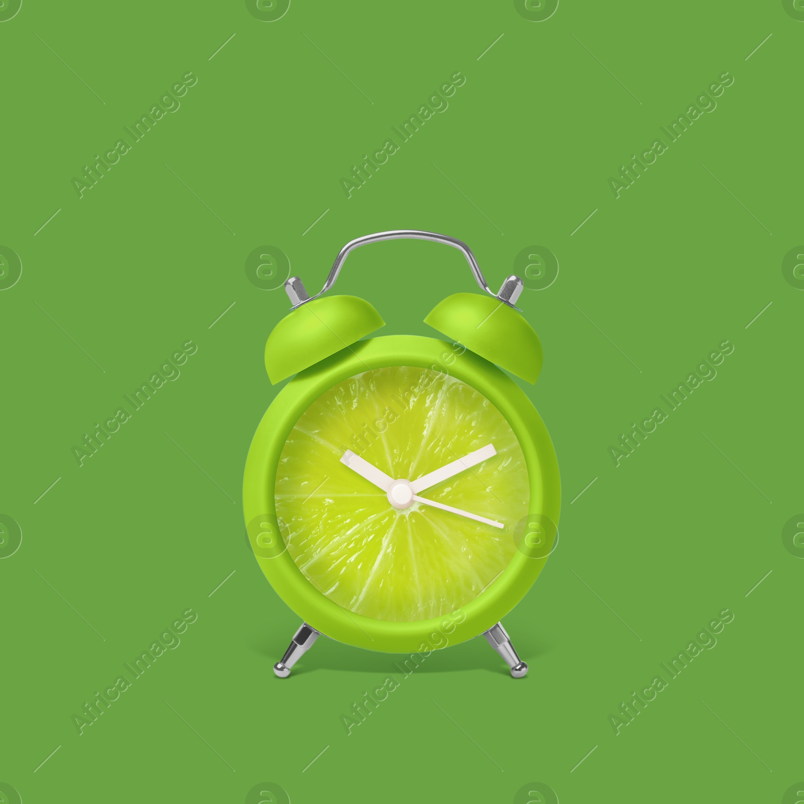 Image of Juicy lime on alarm clock dial against green background. Creative poster