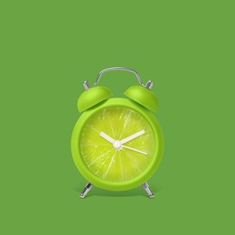 Image of Juicy lime on alarm clock dial against green background. Creative poster