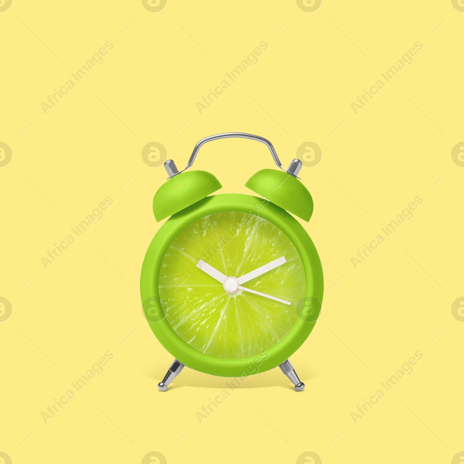 Image of Juicy lime on alarm clock dial against light blue yellow. Creative poster