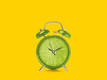 Image of Juicy lime on alarm clock dial against golden background. Creative poster