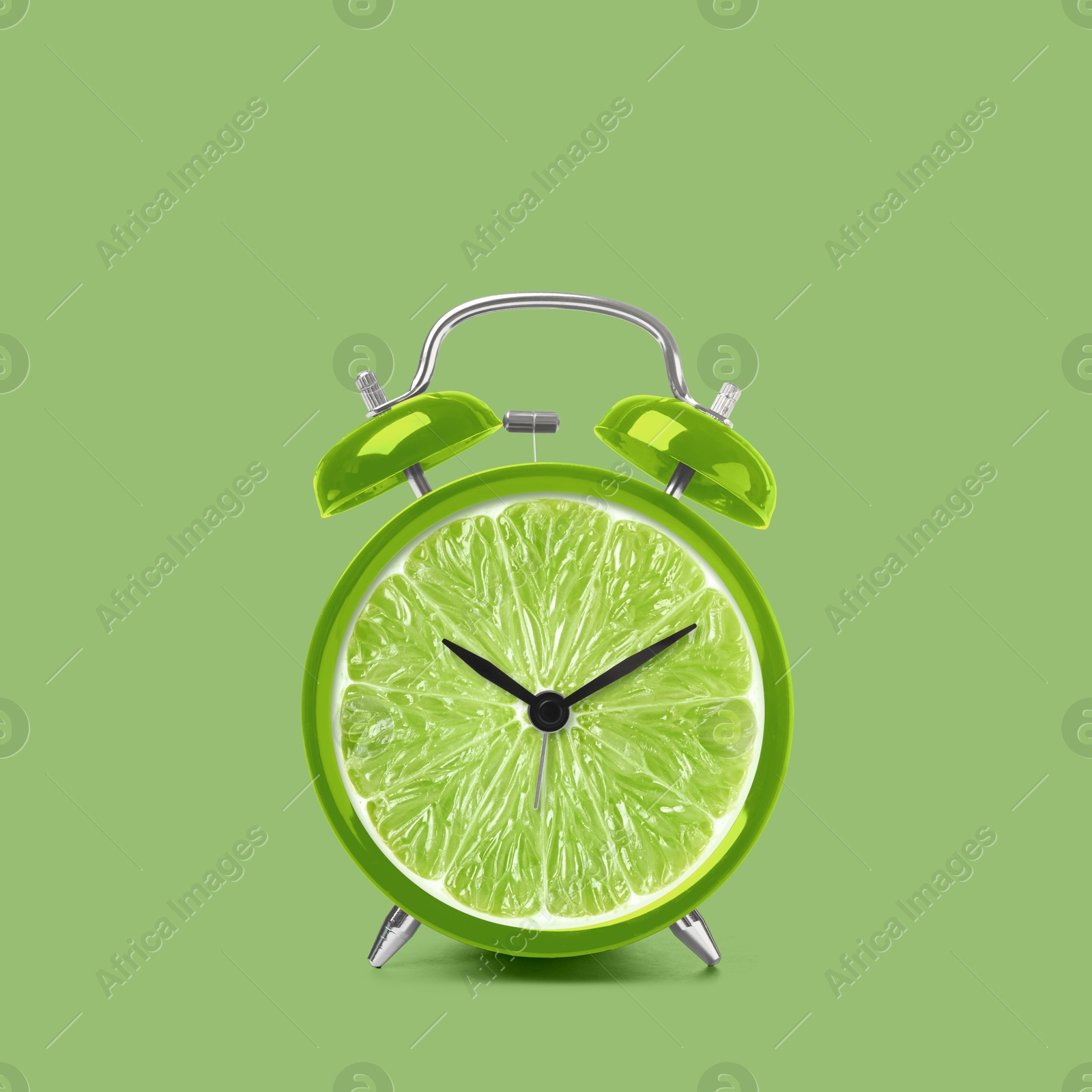 Image of Juicy lime on alarm clock dial against light green background. Creative poster