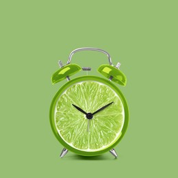 Image of Juicy lime on alarm clock dial against light green background. Creative poster