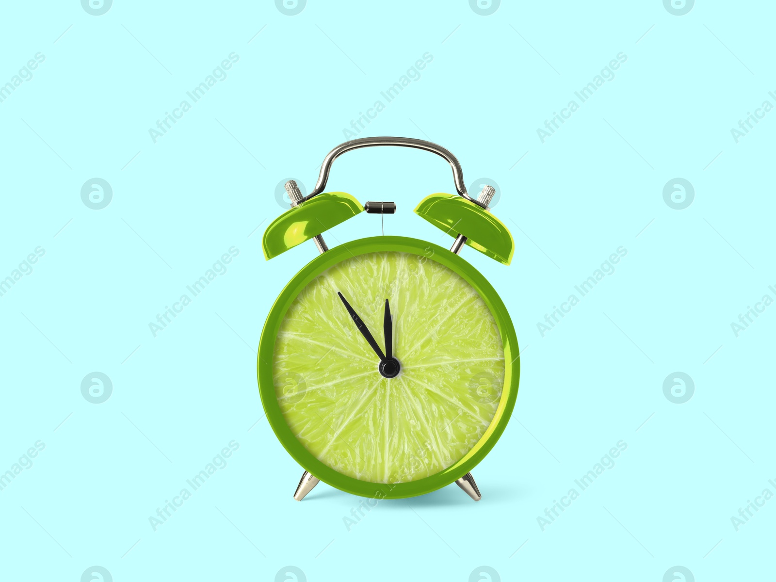 Image of Juicy lime on alarm clock dial against light blue background. Creative poster