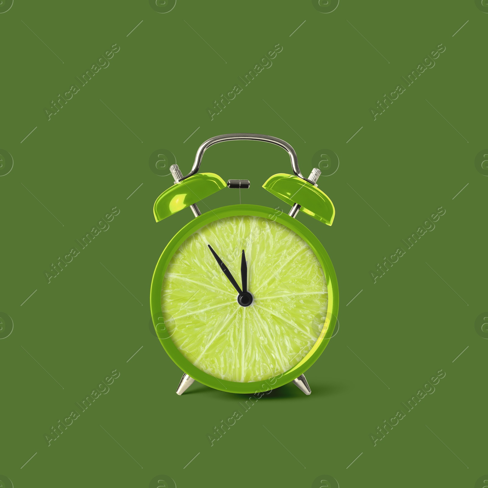 Image of Juicy lime on alarm clock dial against green background. Creative poster