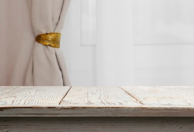 Image of Empty white wooden table near window with curtains. Space for design