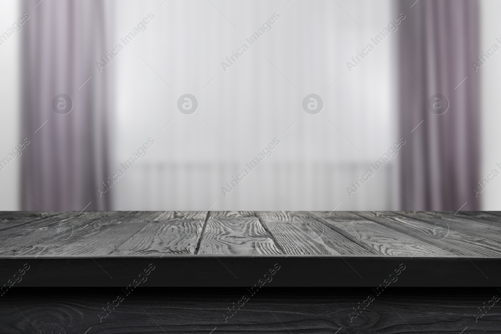 Image of Empty black wooden table near window with curtains. Space for design