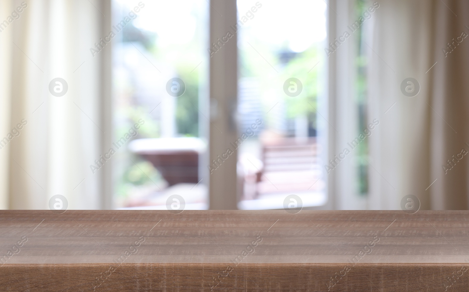 Image of Empty wooden table near window with curtains. Space for design