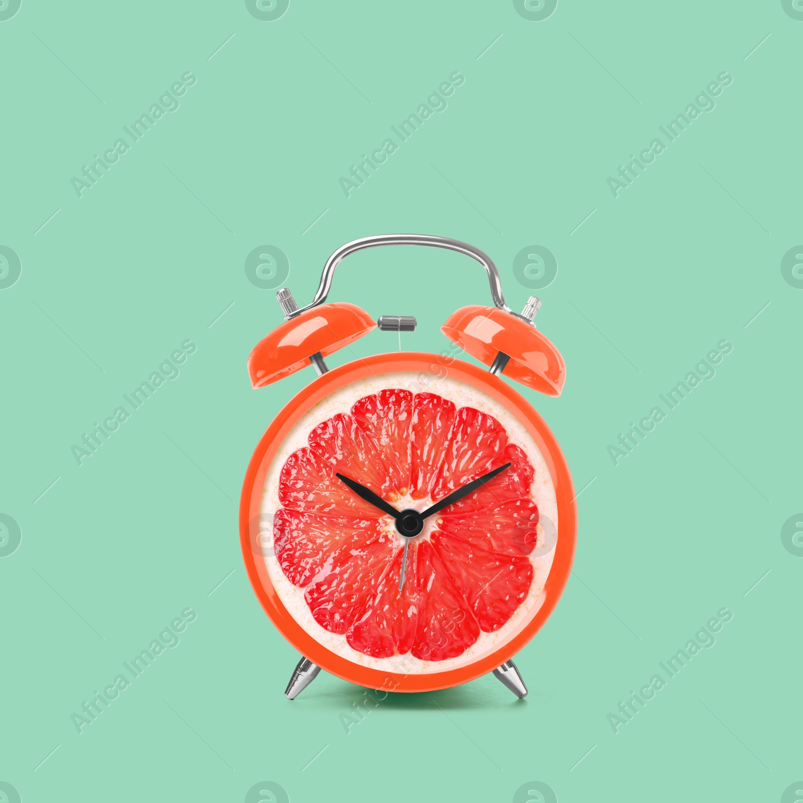 Image of Juicy grapefruit on alarm clock dial against turquoise background. Creative poster