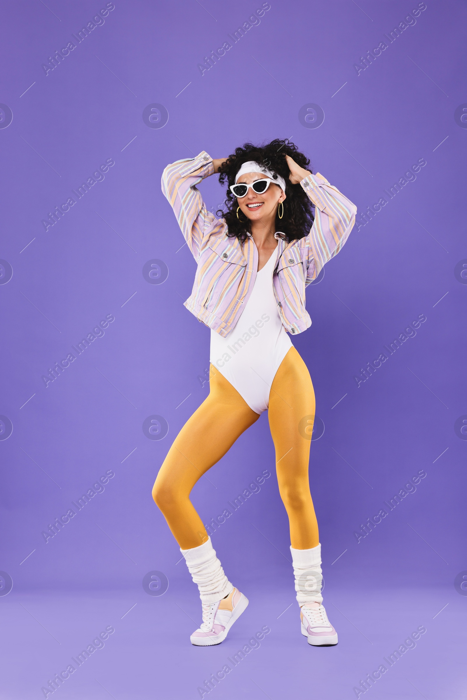 Photo of Aerobics. Happy woman in sunglasses on purple background