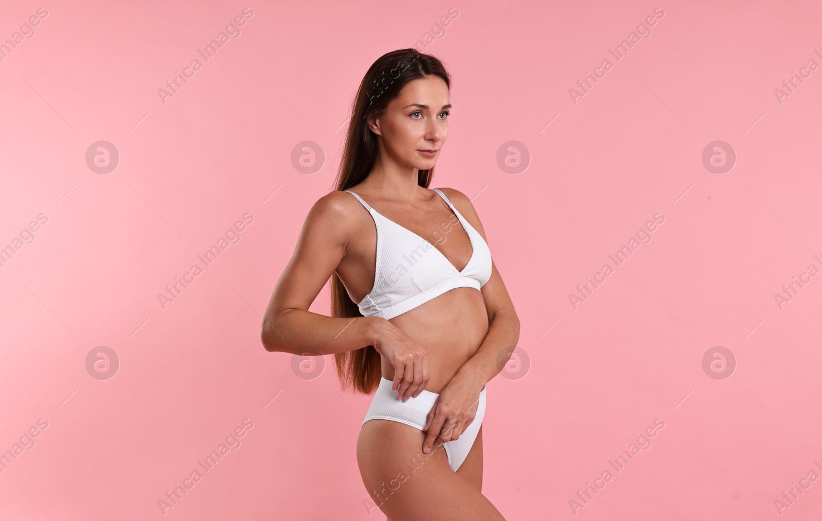 Photo of Beautiful woman with perfect skin on pink background. Body care