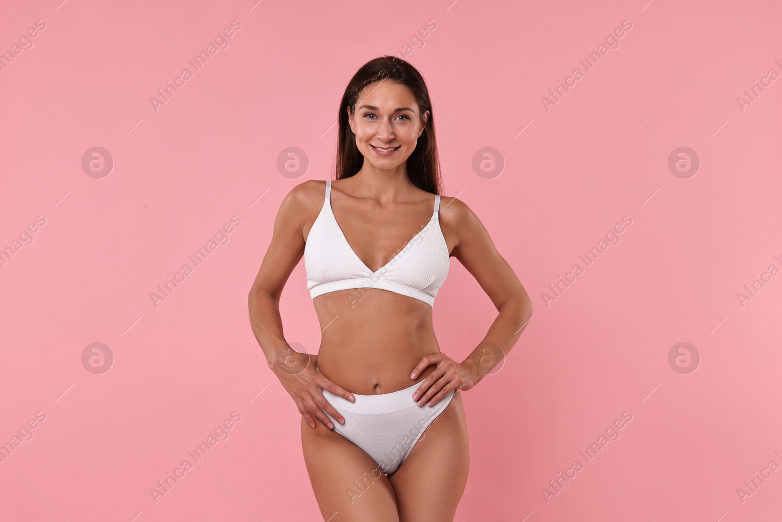 Photo of Smiling woman with perfect skin on pink background. Body care