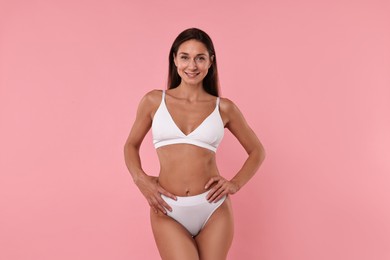 Photo of Smiling woman with perfect skin on pink background. Body care