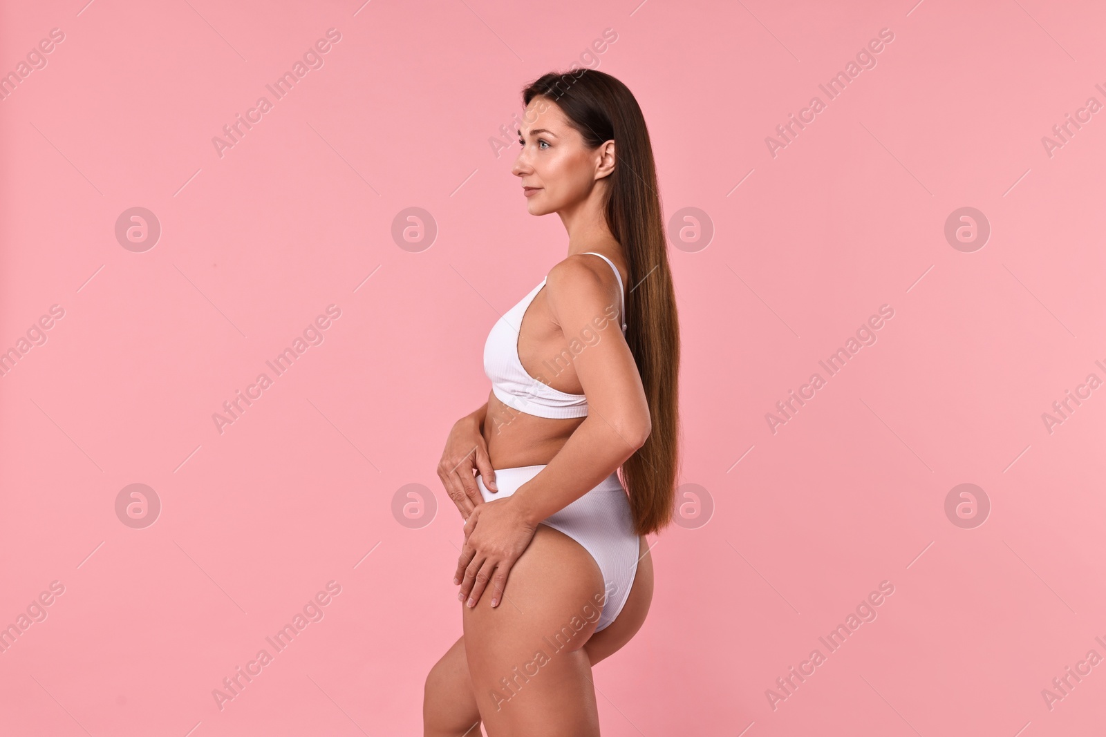 Photo of Beautiful woman with perfect skin on pink background. Body care