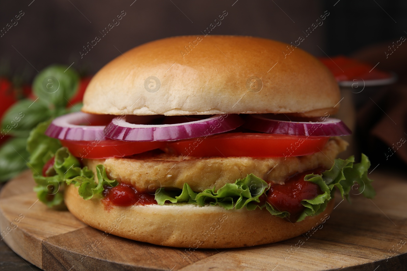 Photo of Delicious vegan burger with chickpea cutlet on wooden table, closeup