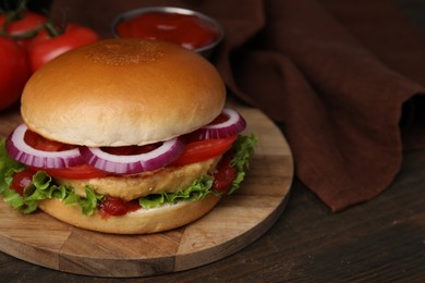 Photo of Delicious vegan burger with chickpea cutlet on wooden table, closeup