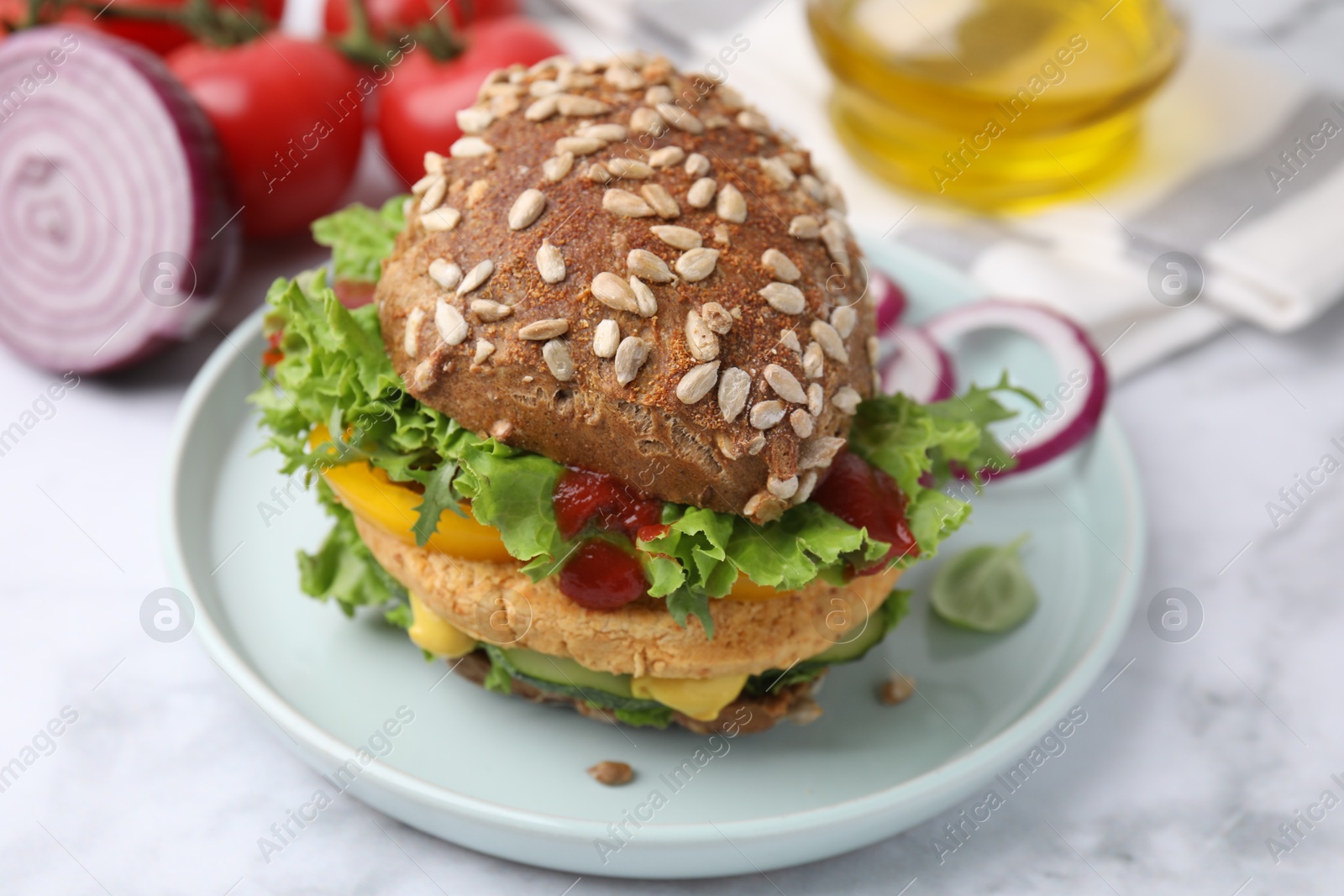 Photo of Delicious vegan burger with chickpea cutlet on white marble table, closeup