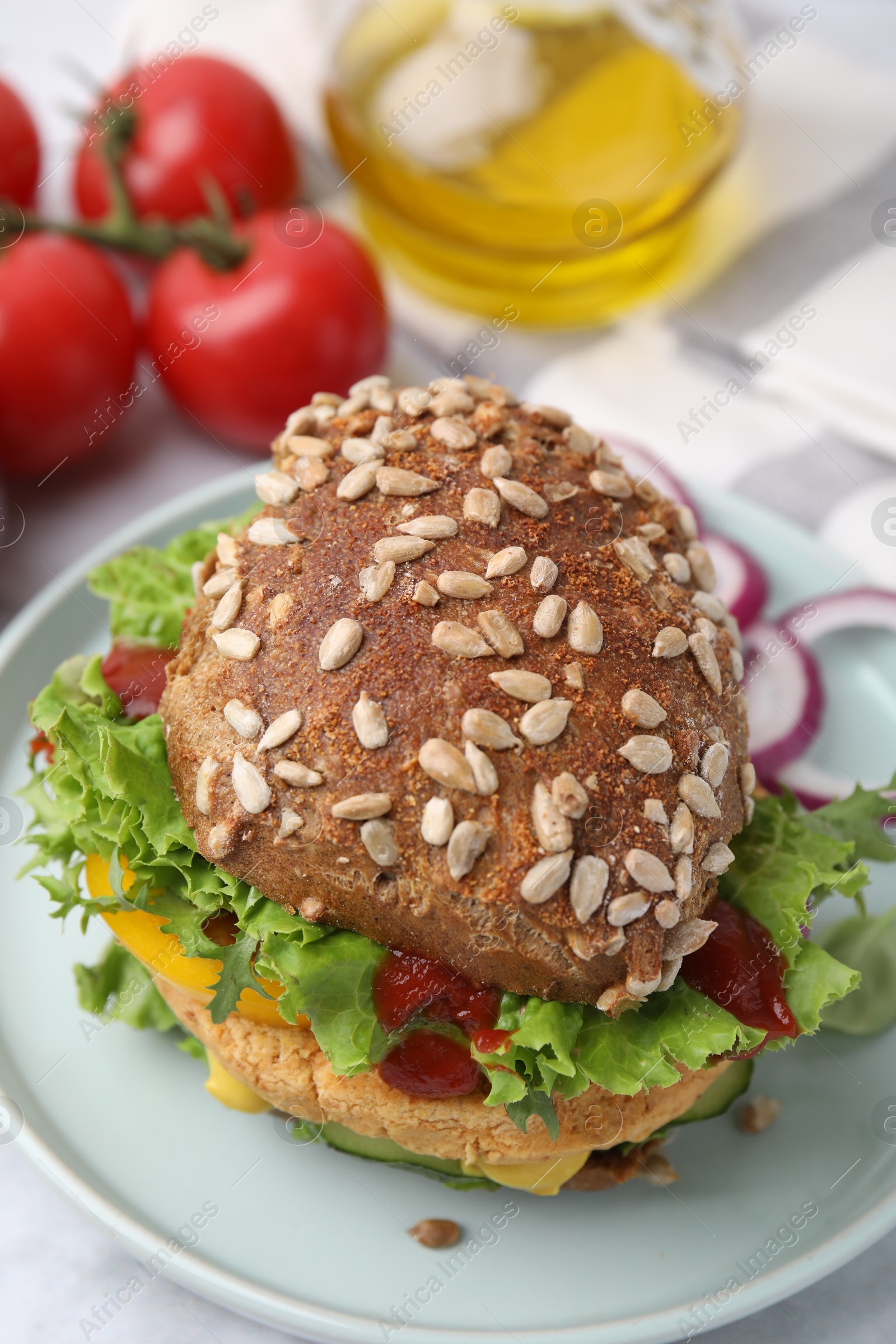 Photo of Delicious vegan burger with chickpea cutlet on white marble table, closeup