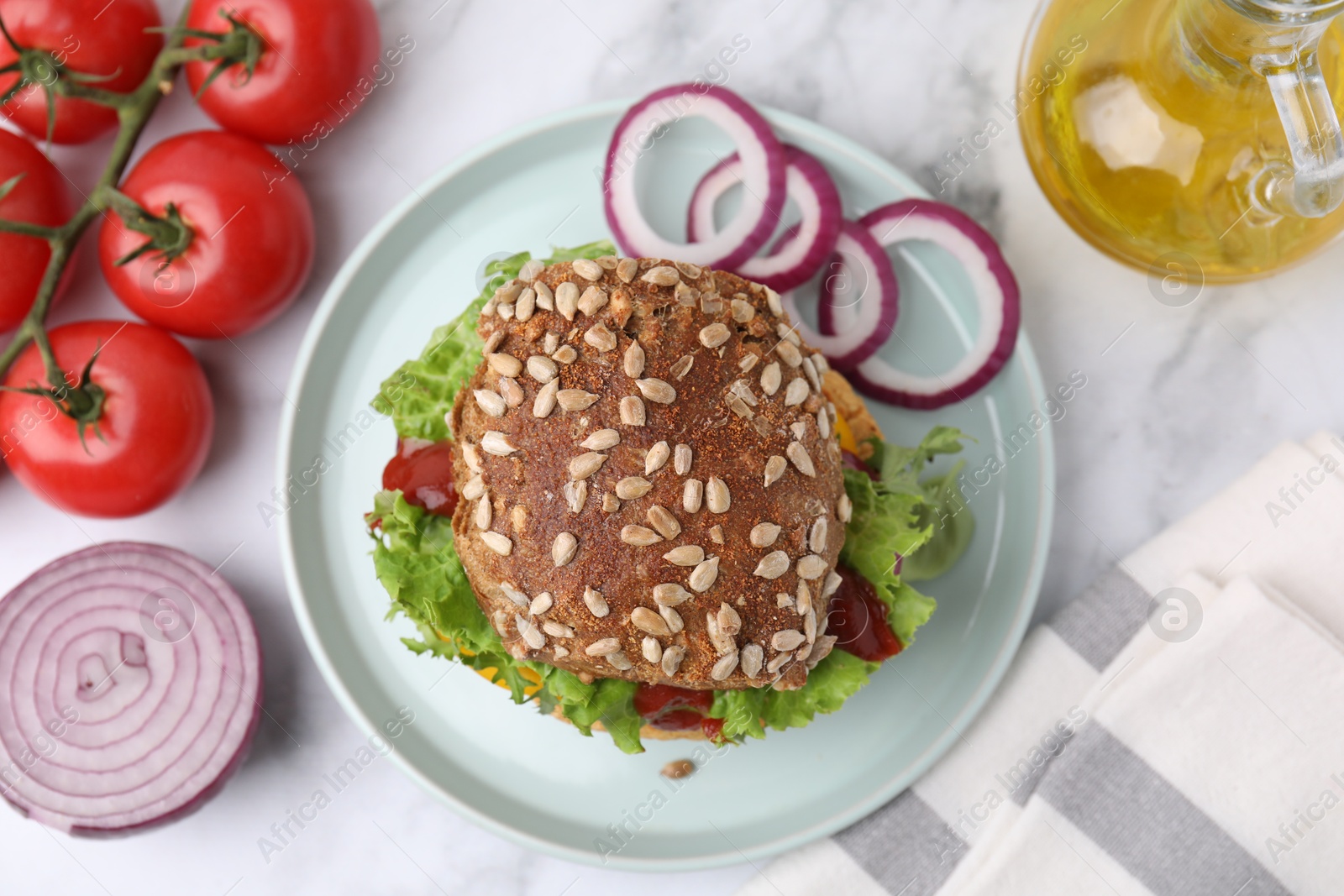 Photo of Delicious vegan burger with chickpea cutlet on white marble table, flat lay