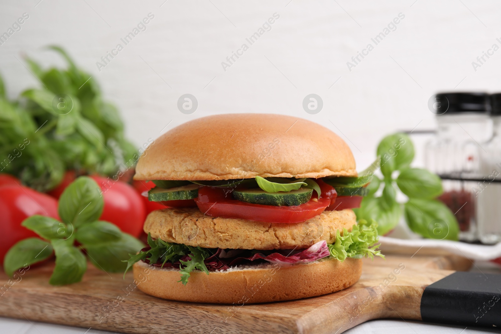 Photo of Delicious vegan burger with chickpea cutlet on table