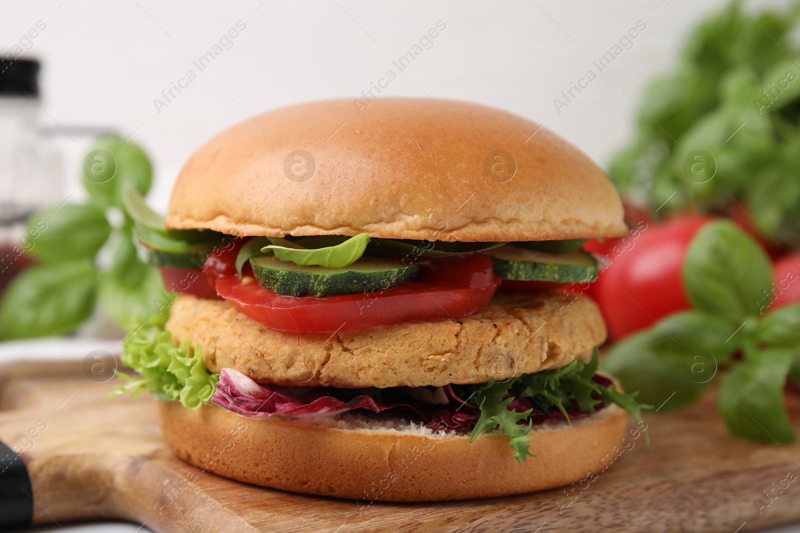 Photo of Delicious vegan burger with chickpea cutlet on table, closeup