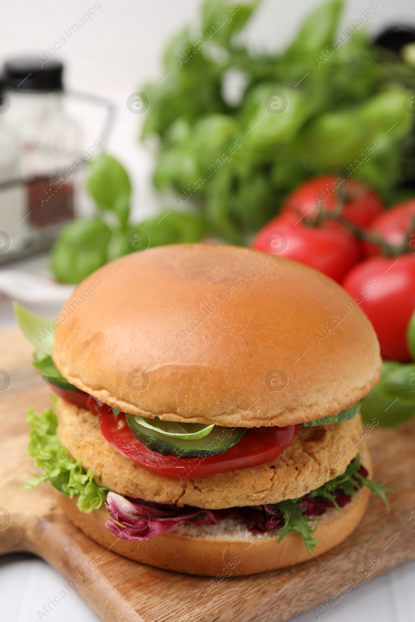 Photo of Delicious vegan burger with chickpea cutlet on table, closeup