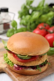 Delicious vegan burger with chickpea cutlet on table, closeup