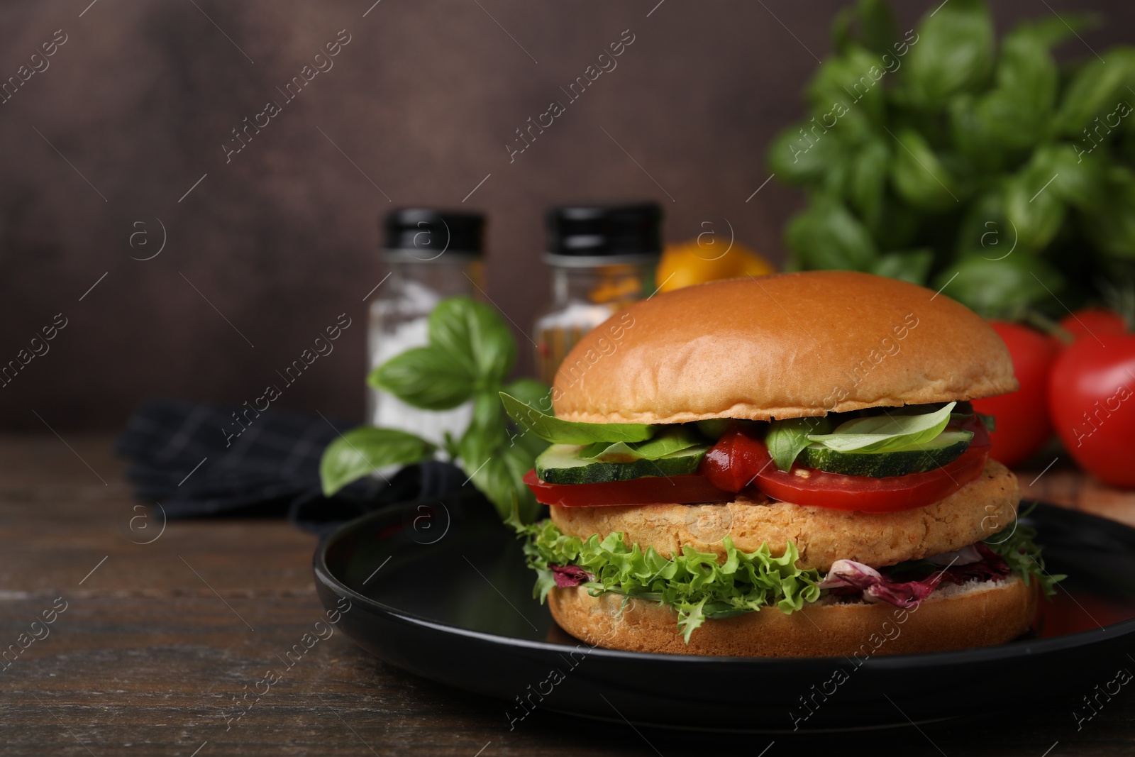 Photo of Delicious vegan burger with chickpea cutlet on wooden table