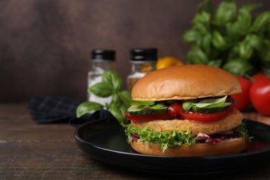 Photo of Delicious vegan burger with chickpea cutlet on wooden table