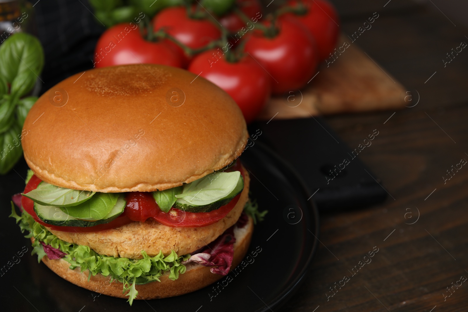 Photo of Delicious vegan burger with chickpea cutlet on wooden table, closeup