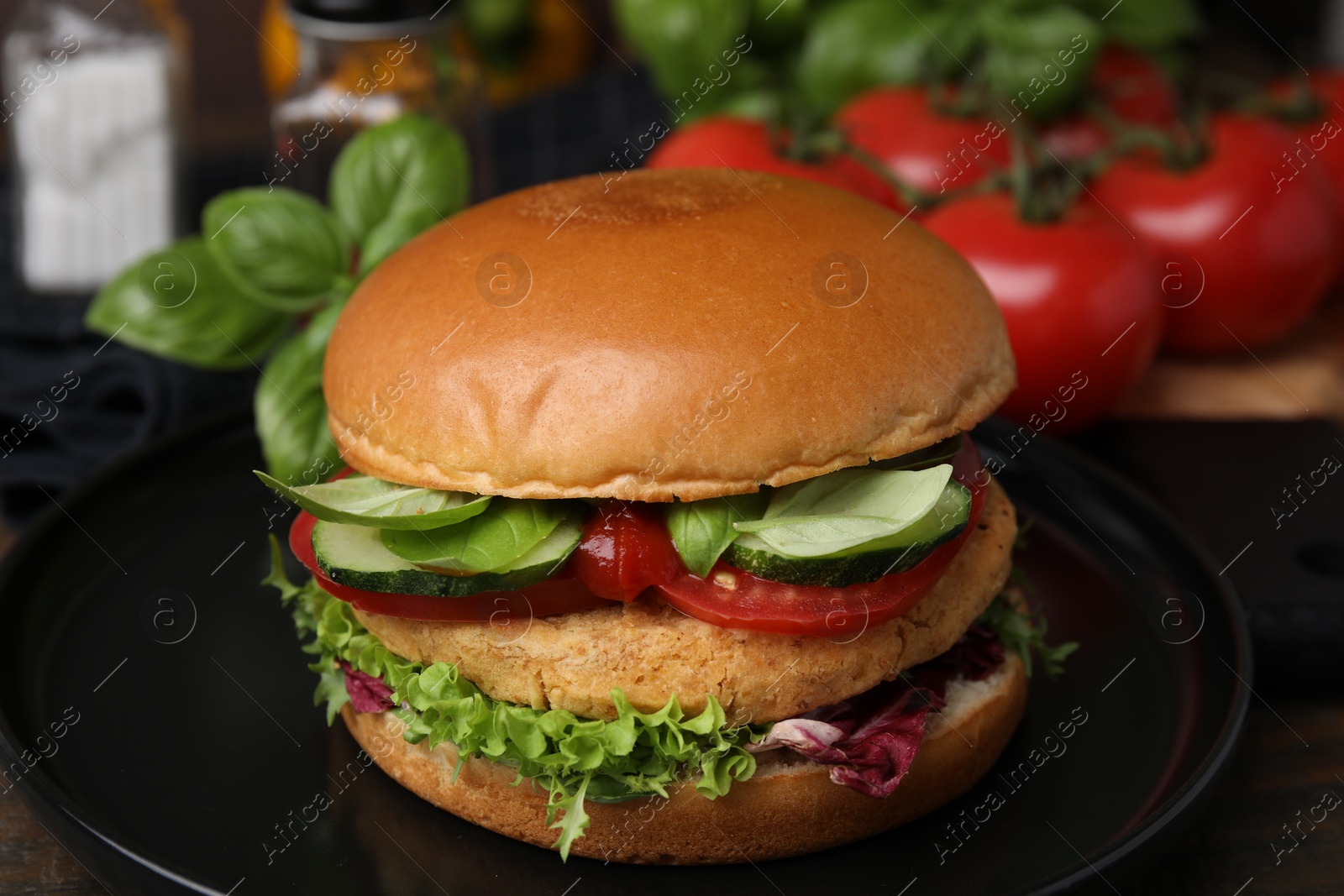 Photo of Delicious vegan burger with chickpea cutlet on wooden table, closeup