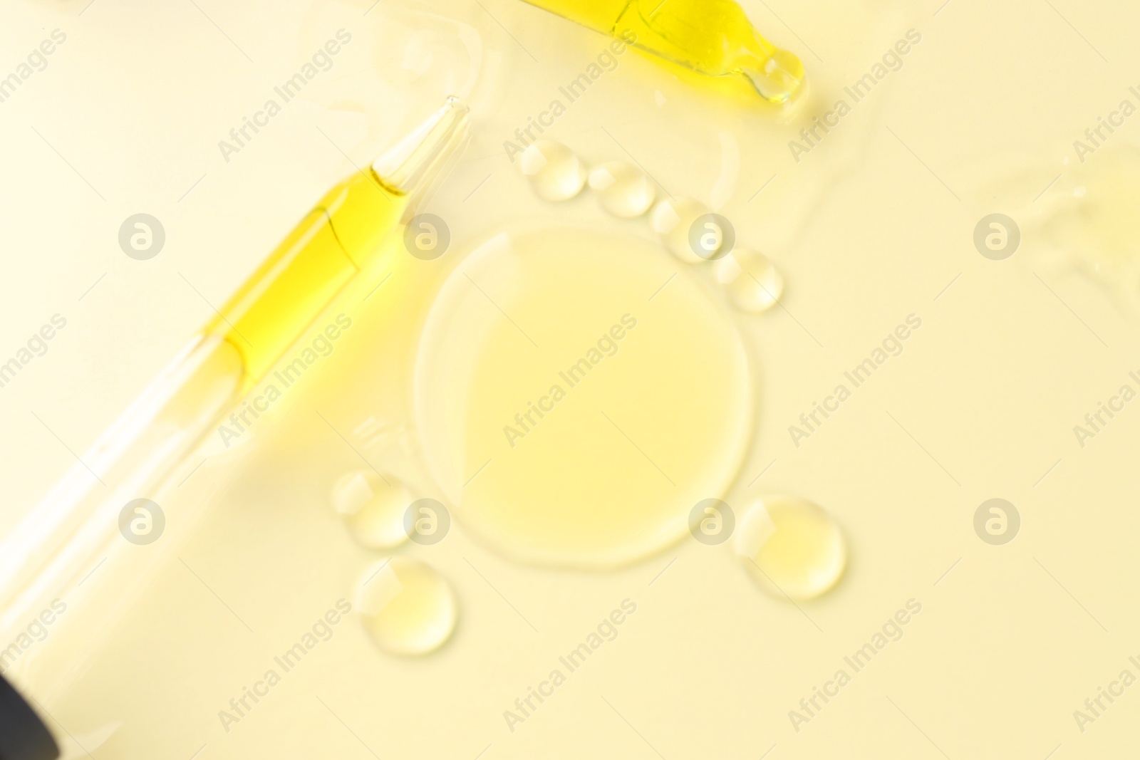 Photo of Cosmetic oil and pipettes on dark beige background, flat lay