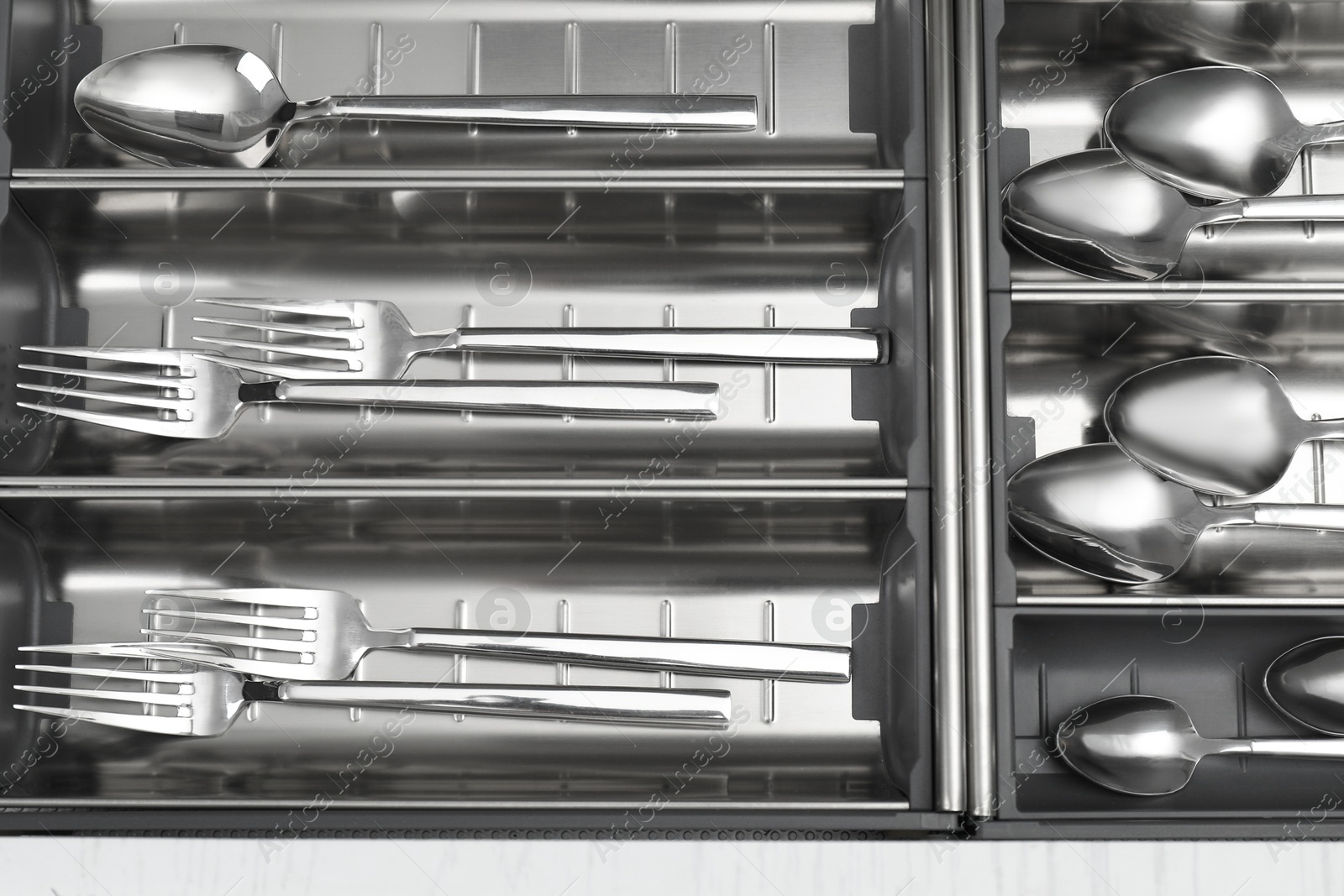 Photo of Box with cutlery in drawer, top view. Kitchen utensils storage