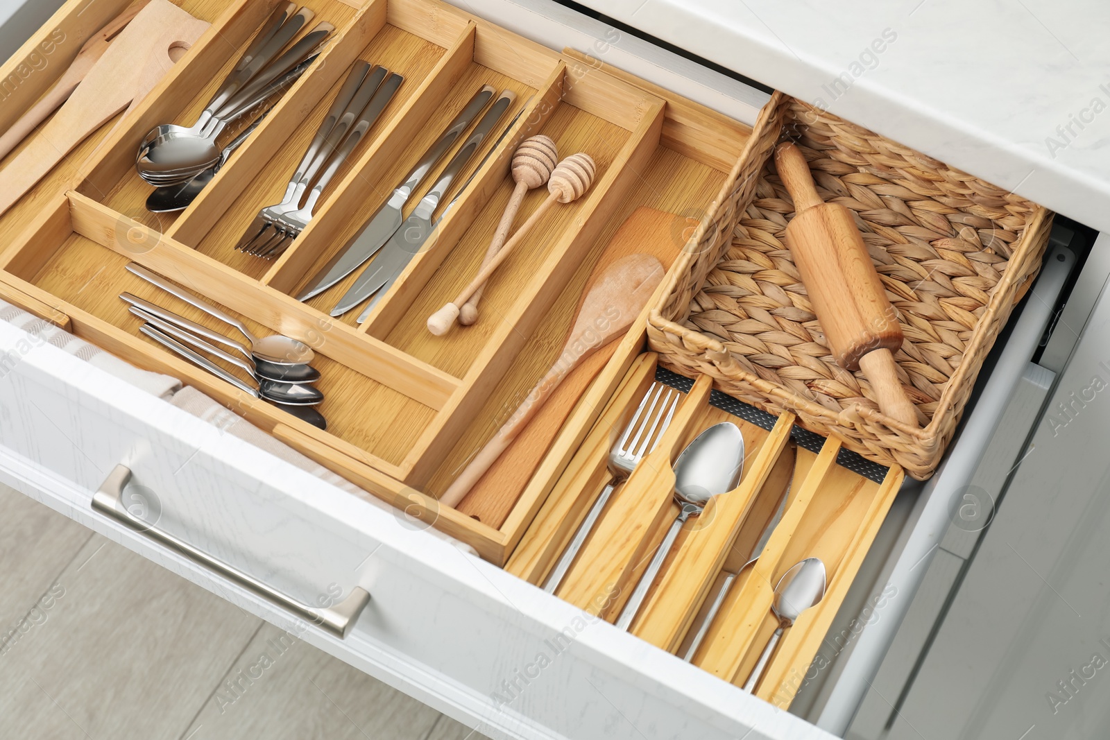 Photo of Box with cutlery in drawer, closeup. Kitchen utensils storage