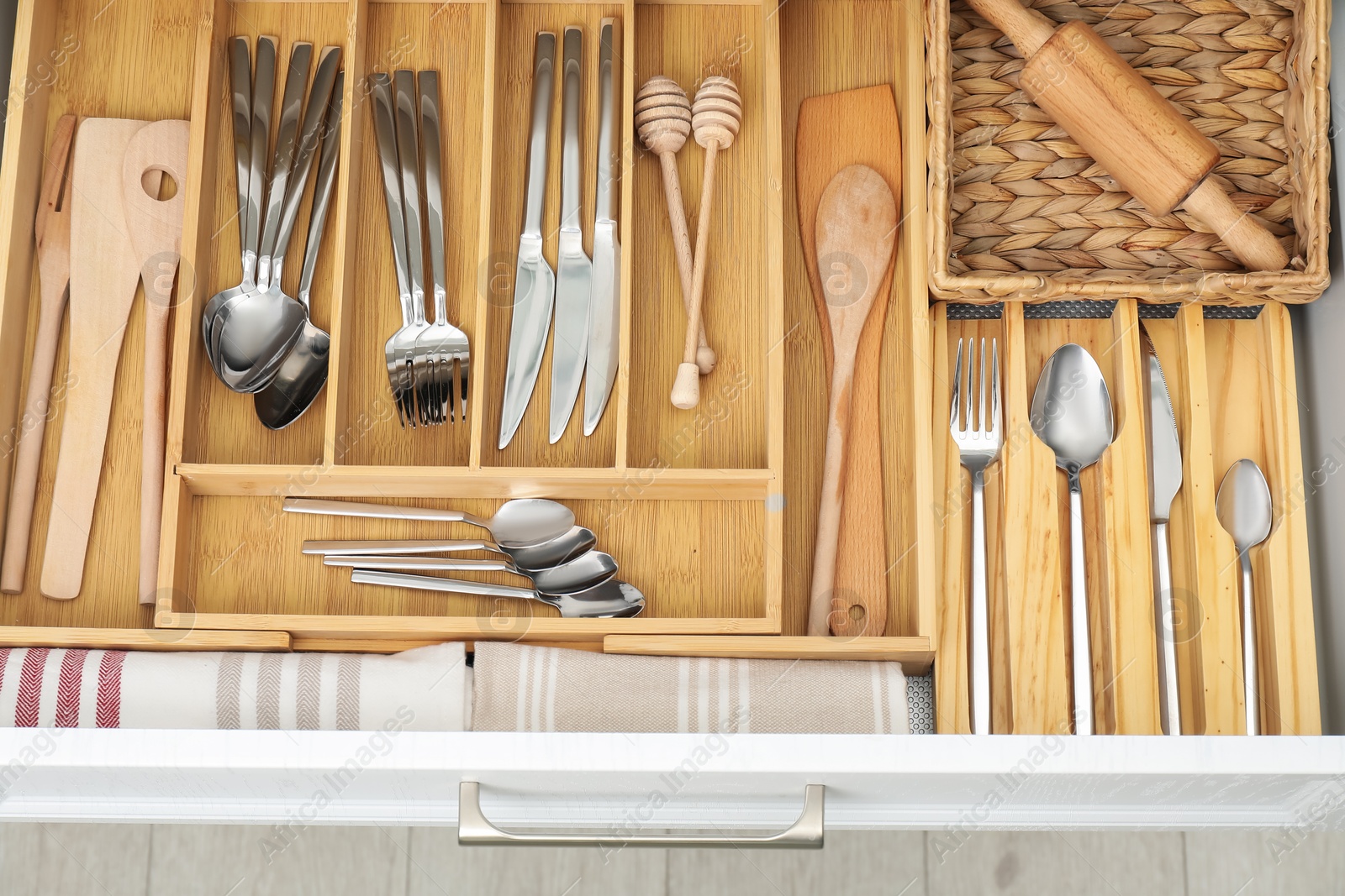 Photo of Box with cutlery in drawer, closeup. Kitchen utensils storage