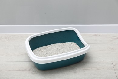 Cat tray with clumping litter on floor indoors